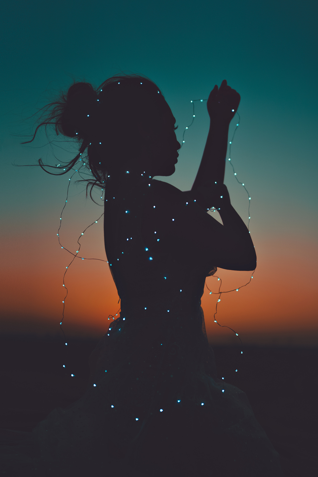 Silhouette of Woman Holding String Slights